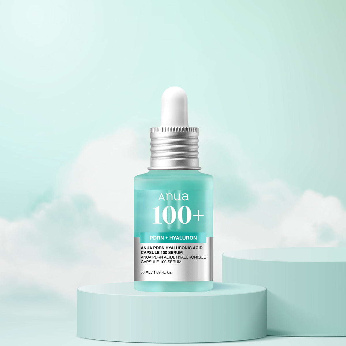 Anua 100+ serum bottle with dropper on a light blue background