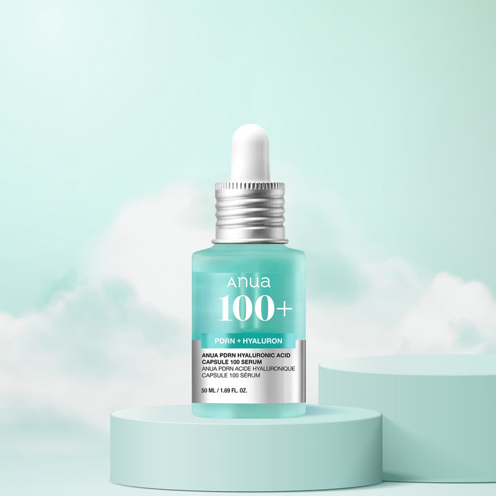 Anua 100+ serum bottle with dropper on a light blue background