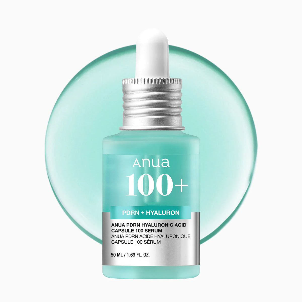 Anua 100+ serum bottle with dropper on a light green background