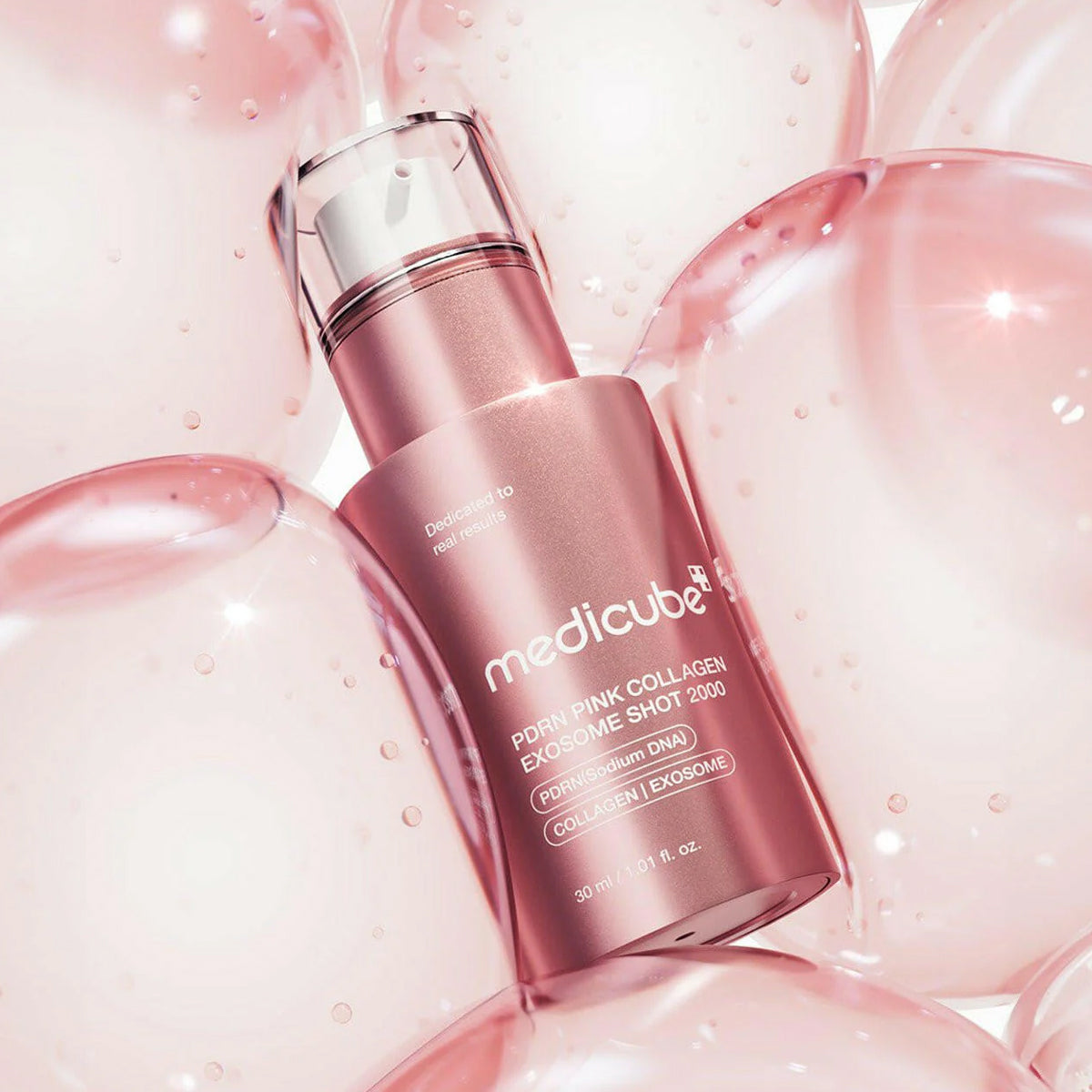 Pink skincare serum bottle with 'medicube' branding on a pink background