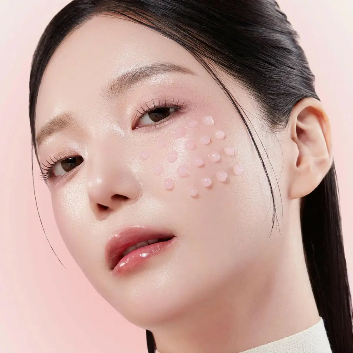 Close-up of a woman's face with a pink background