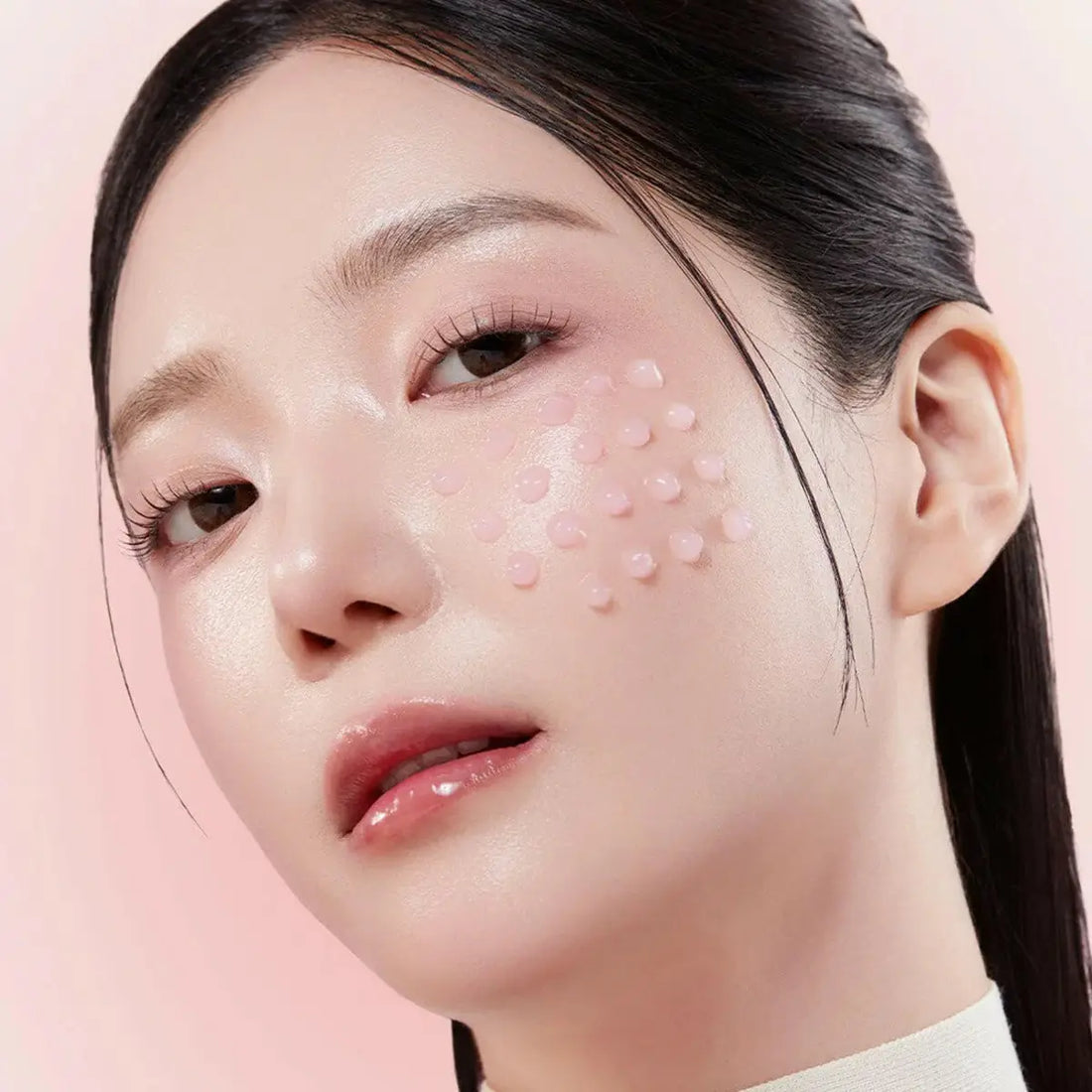 Close-up of a woman's face with a pink background