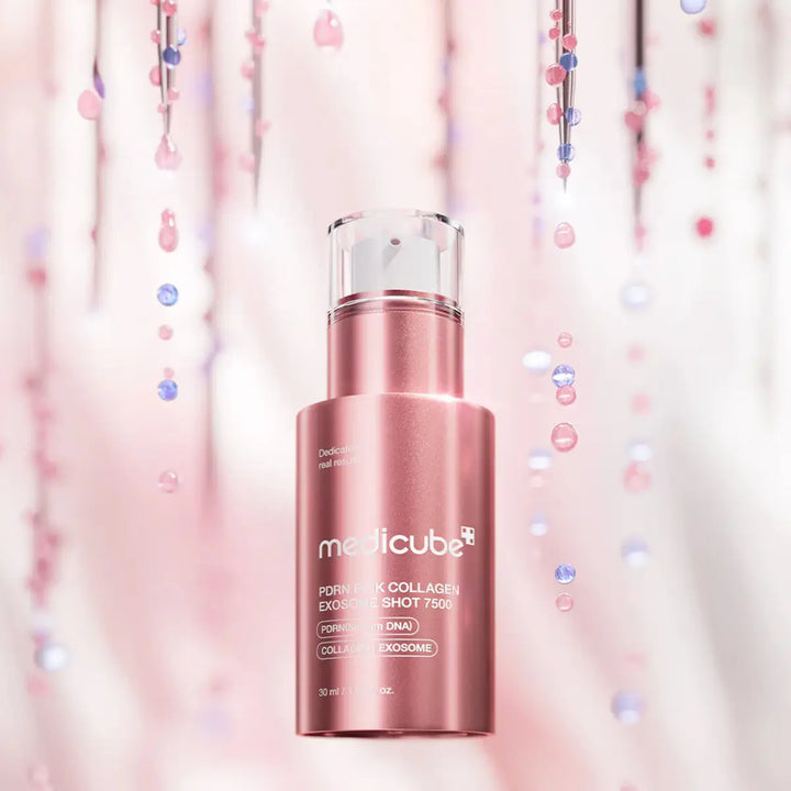 Pink skincare bottle with 'medicube' branding on a soft pink background with confetti.