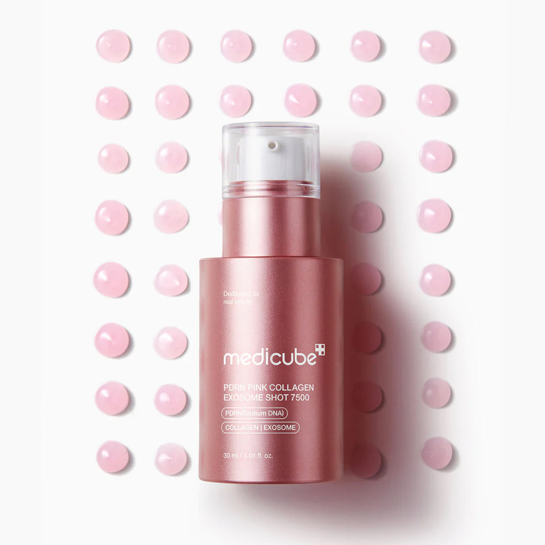 Pink skincare product with 'medicube' branding on a white background with pink dots.