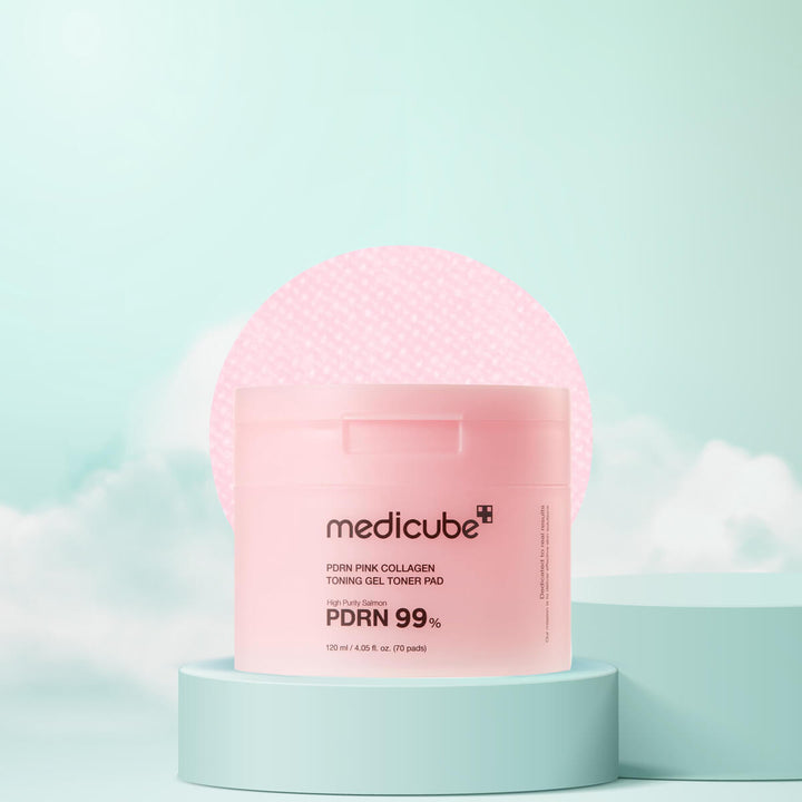 Pink packaging of Medicube product on a light blue background
