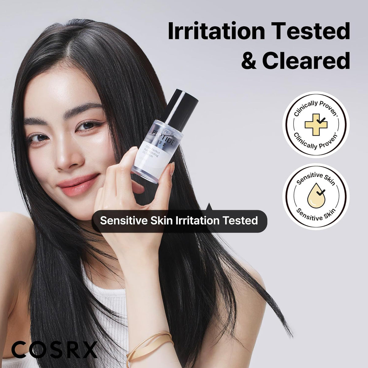 Woman holding a skincare product with 'COSRX' branding and irritation testing claims on a gray background.