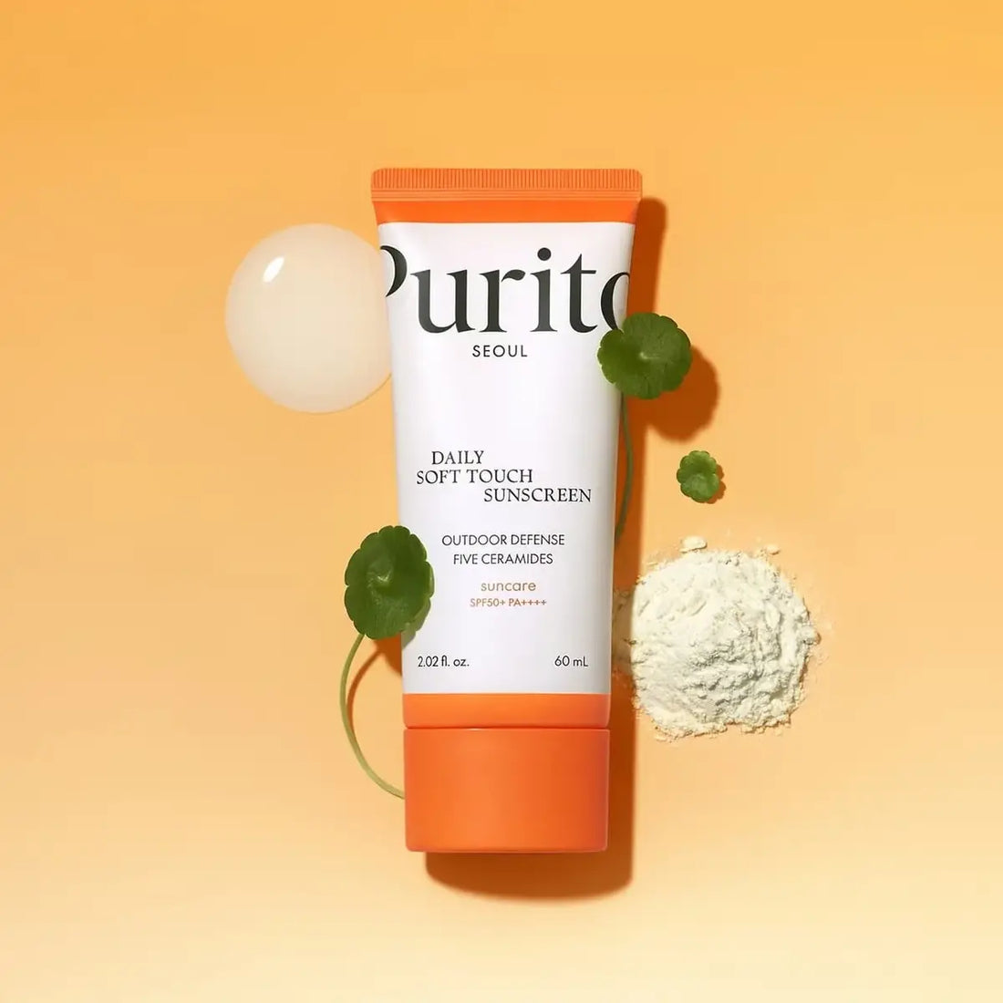 Purito Daily Soft Touch Sunscreen tube on an orange background