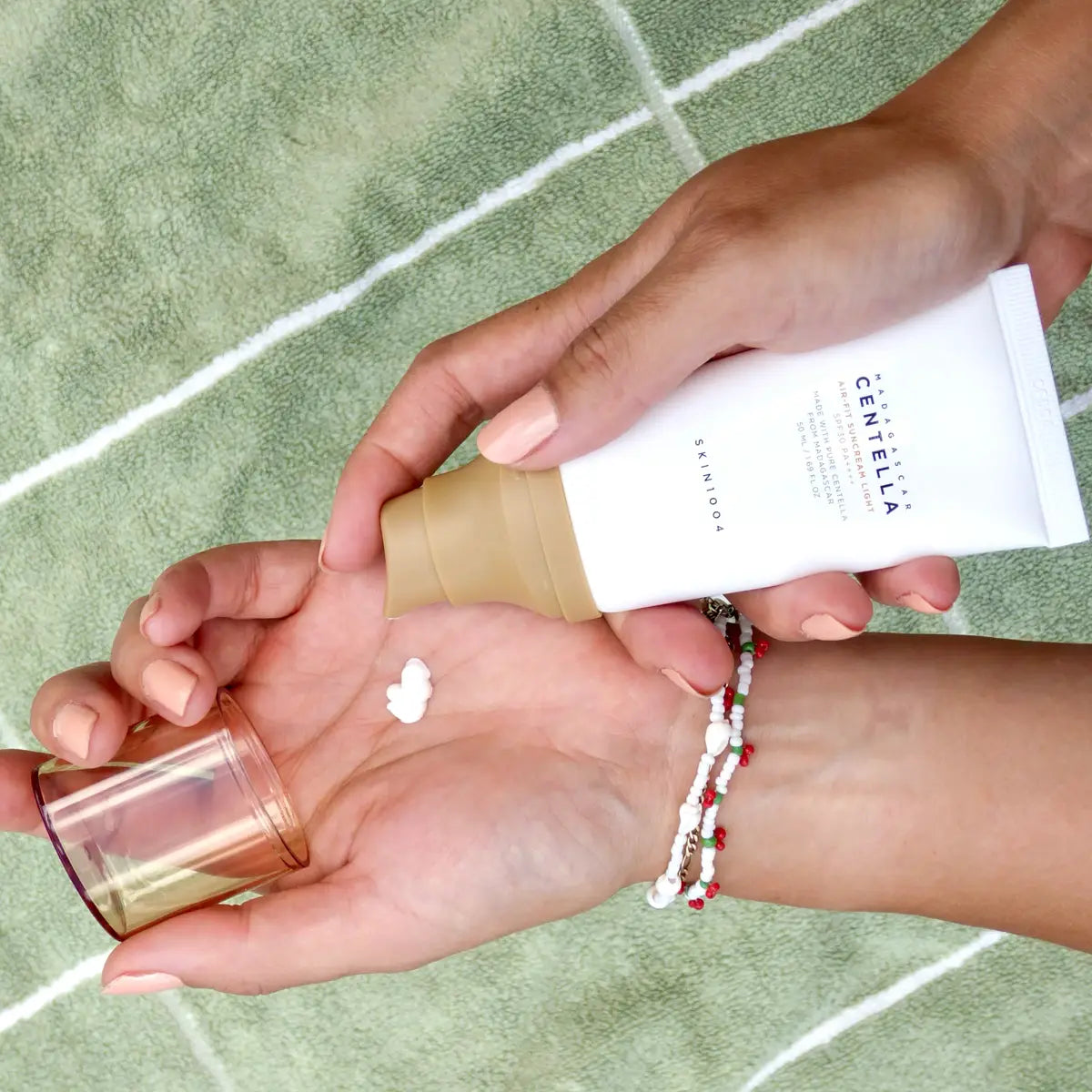 SKIN1004 Madagascar Centella Air-Fit Suncream Light 50mL being appllied on hand
