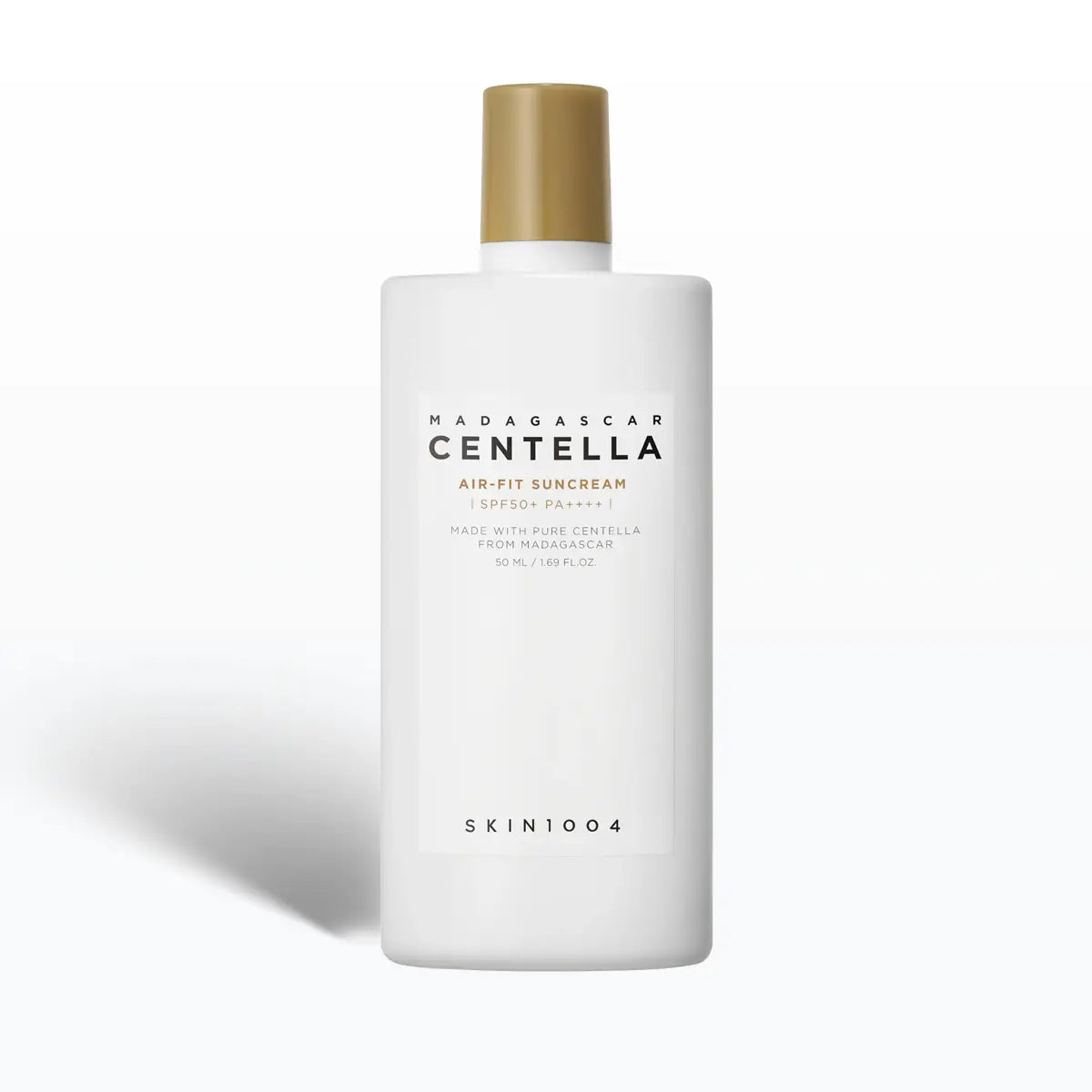 White bottle of Madagascar Centella sunscreen with gold cap on a white background