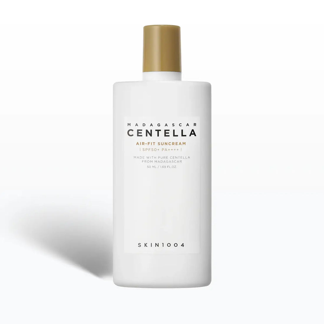 White bottle of Madagascar Centella sunscreen with gold cap on a white background