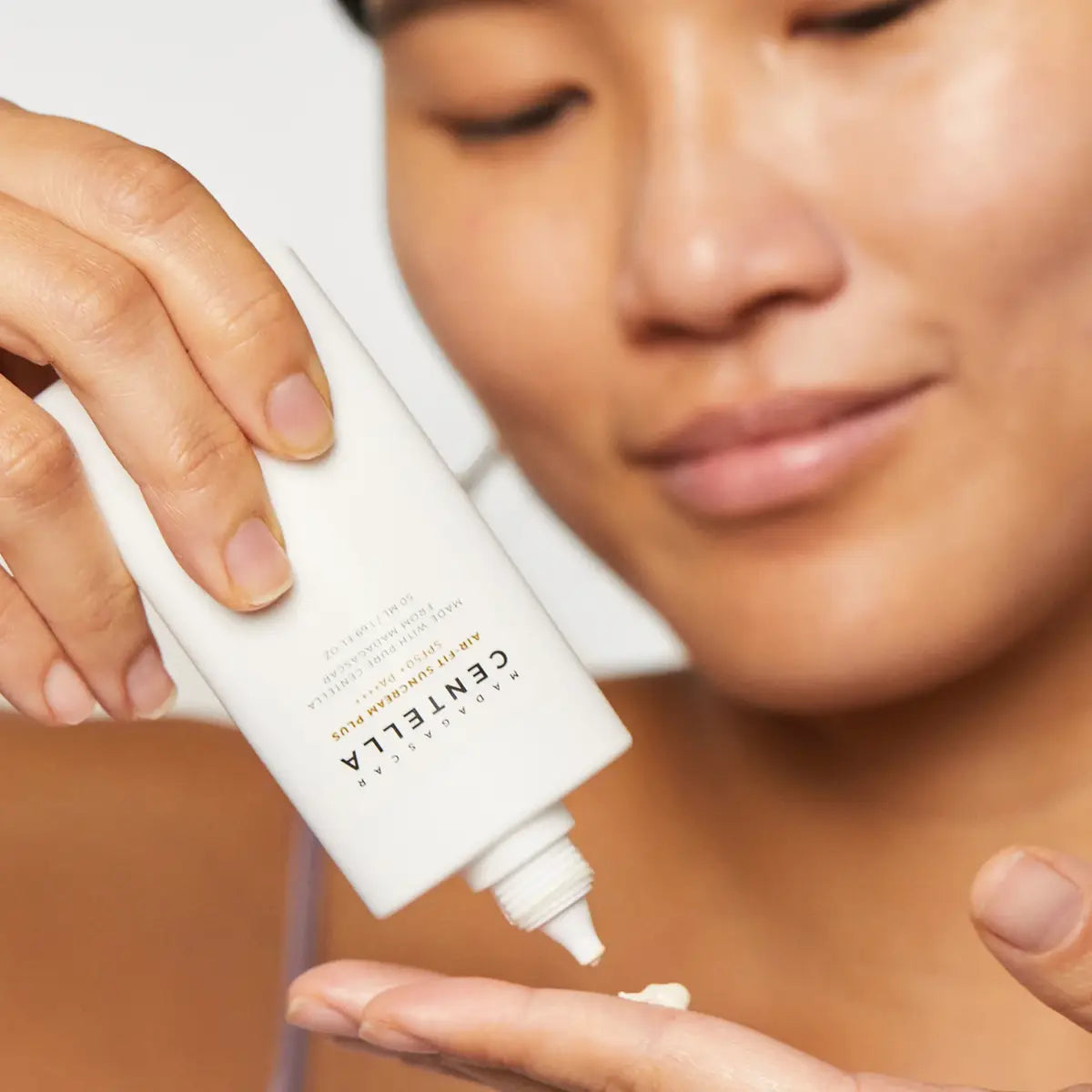 Person applying Centella Asiatica cream to their hand
