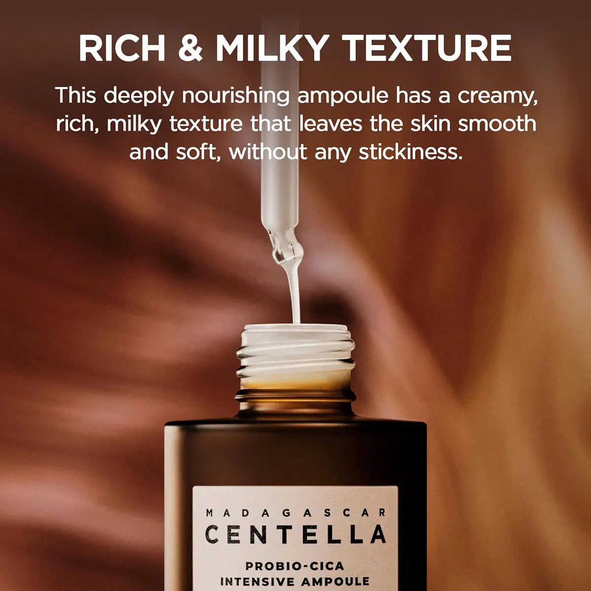 Ampoule bottle with liquid being poured, labeled 'Madagascar Centella Probió-Cica Intensive Ampoule', against a blurred background.