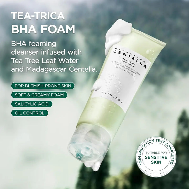 Tea-Trica BHA foam cleanser with tea tree leaf water and Madagascar Centella, against a blurred green background.