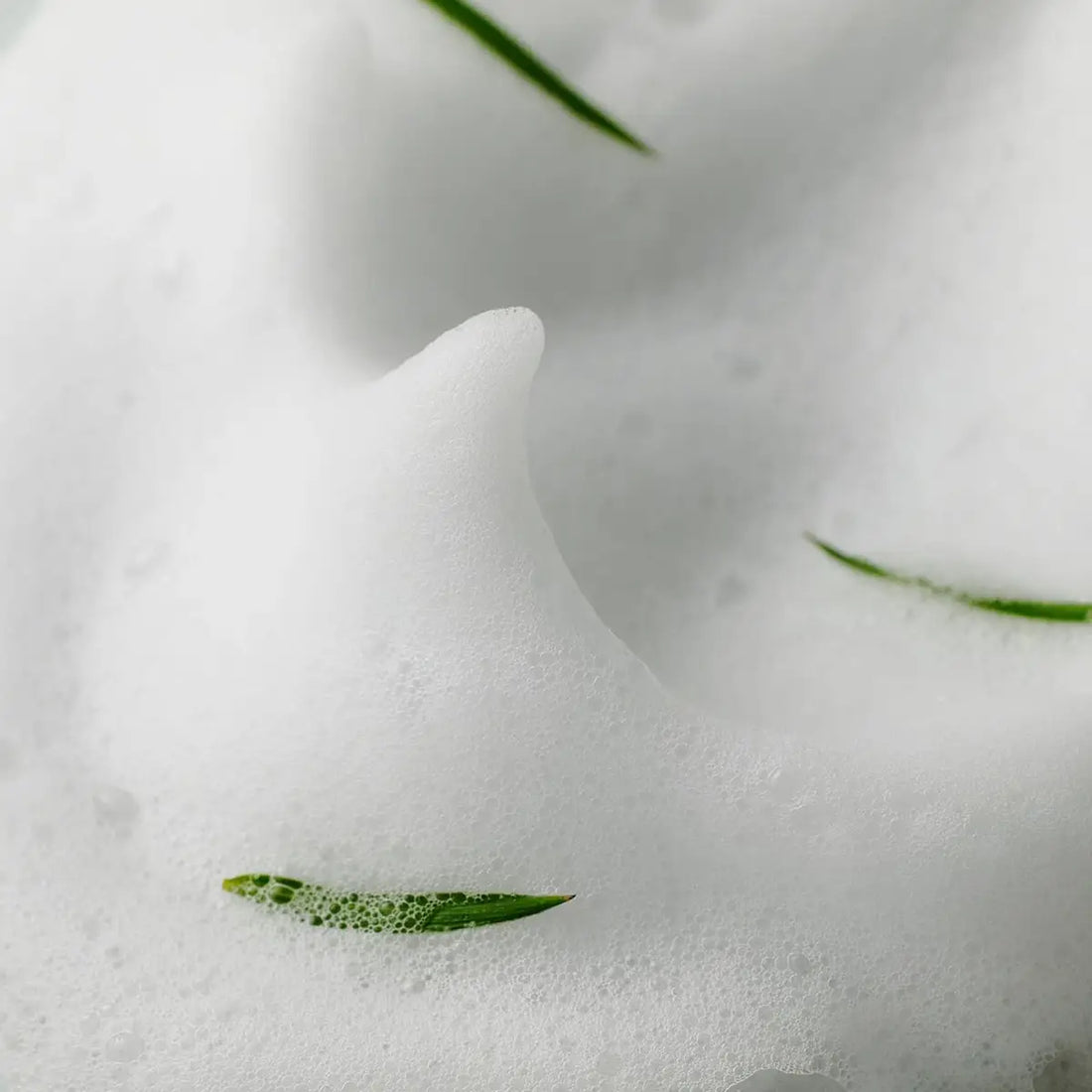 SOME BY MI AHA-BHA-PHA 30 Days Miracle Acne Clear Foam 100mL with foamy texture and green leaves.