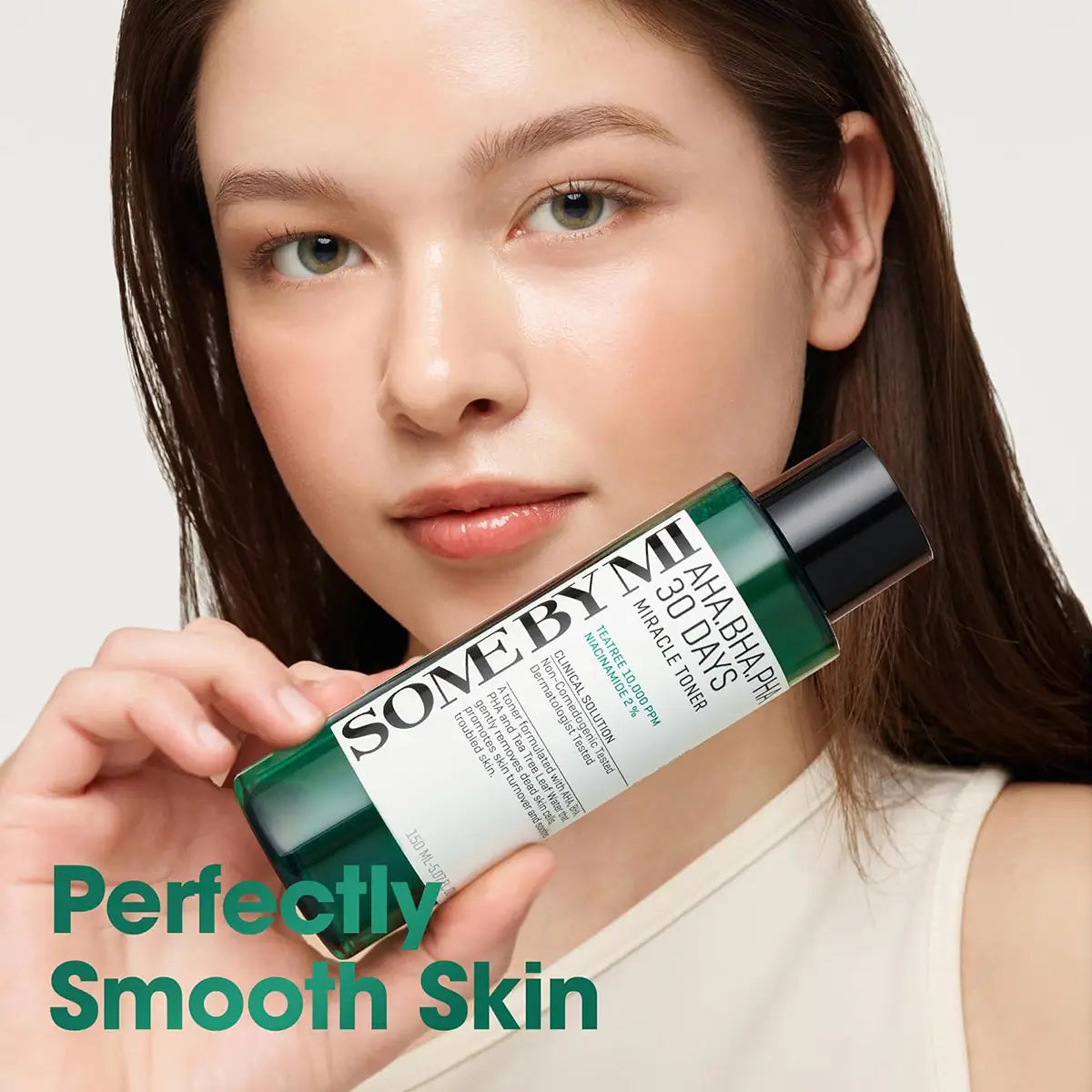 SOME BY MI AHA BHA PHA 30 Days Miracle Toner 150mL held by a model showcasing clear, smooth skin.