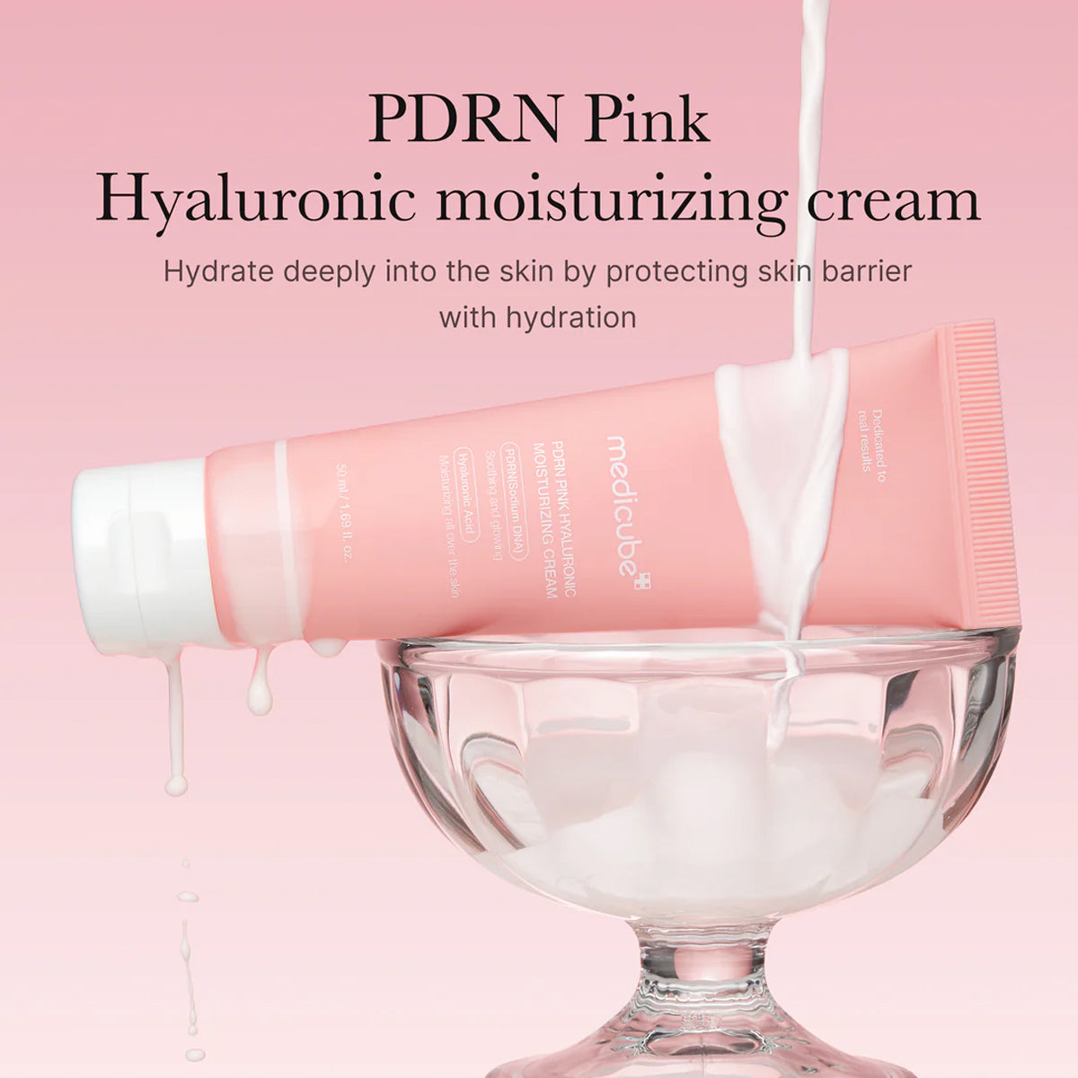 Pink hyaluronic moisturizing cream being poured into a glass bowl with a pink background.