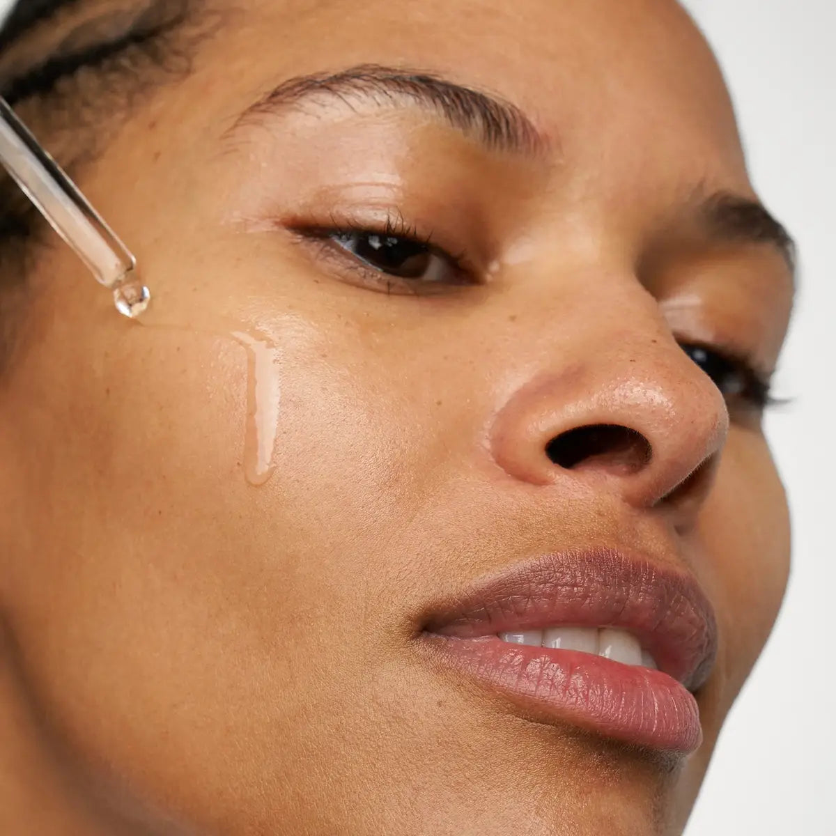 woman applying Skin1004 Madagascar Centella Ampoule on her face