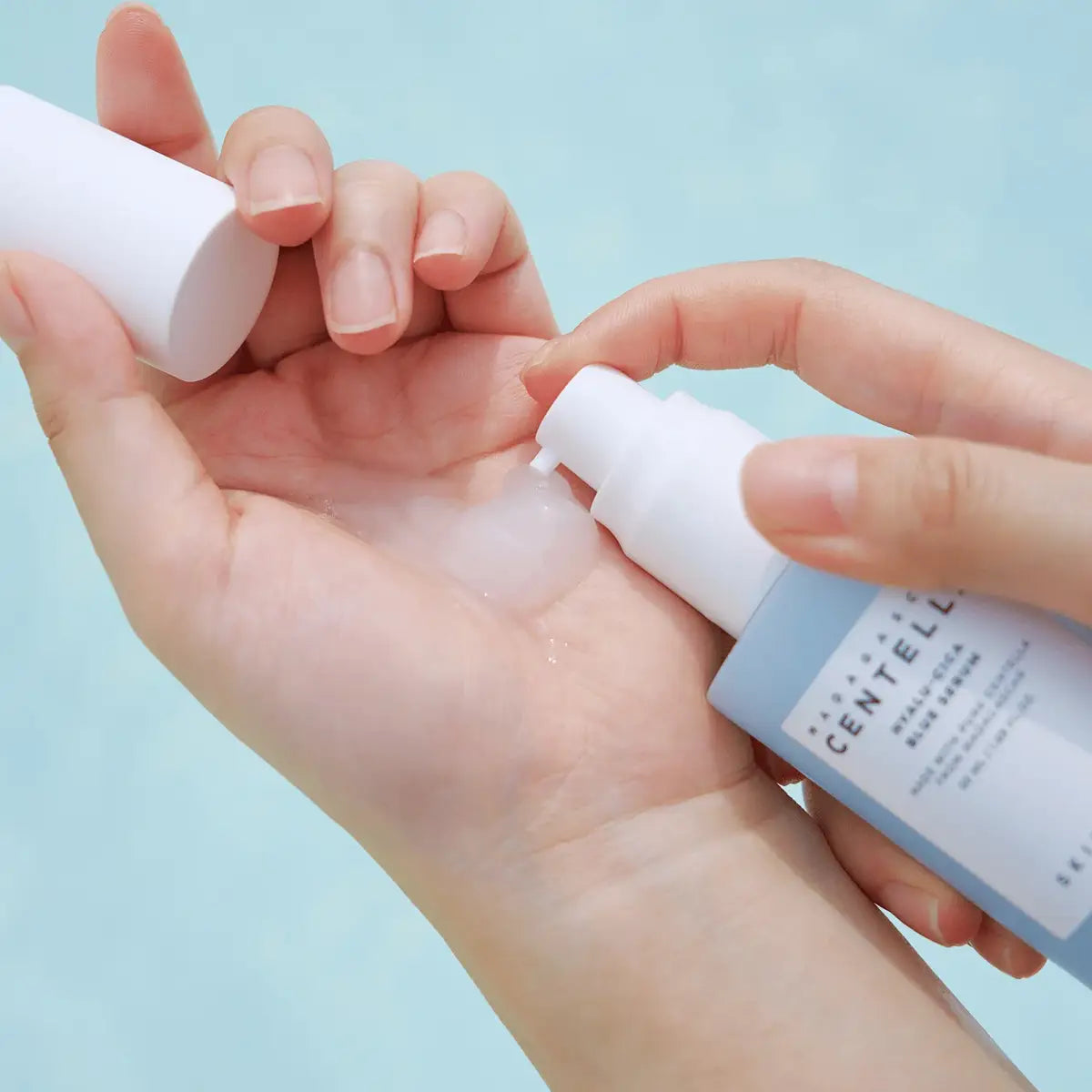 Applying Skin1004 Madagascar Centella Hyalu-Cica Blue Serum on hand