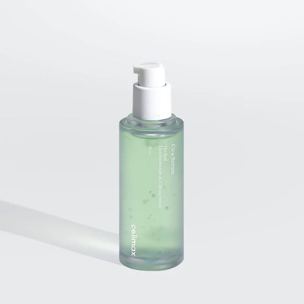 Skincare serum bottle with pump on a light gray background