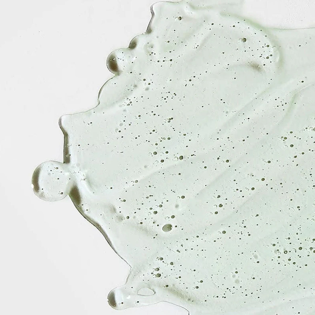 Close-up of a light green concrete surface with speckles