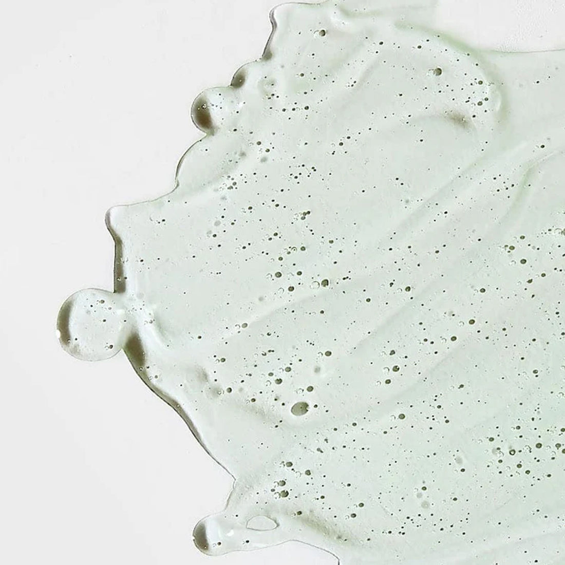 Close-up of a light green concrete surface with speckles