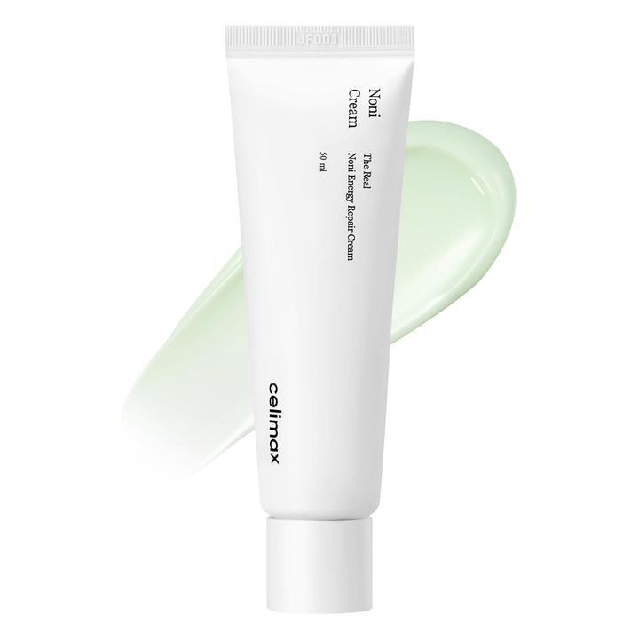 Tube of Nomi Cream with a smear of cream on a white background