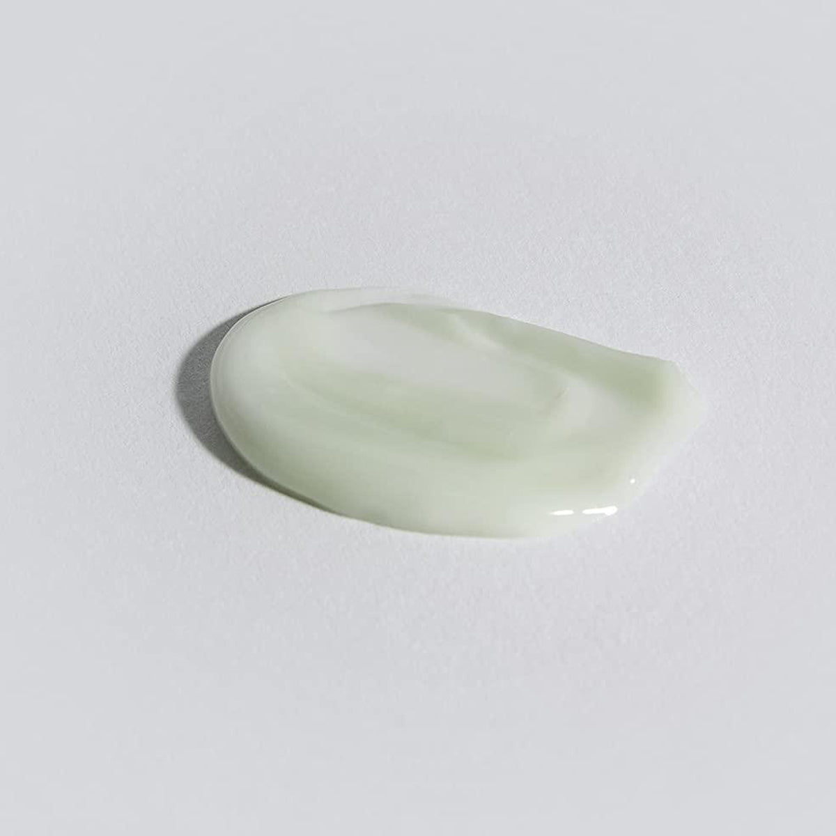 Light green teardrop-shaped object on a white background