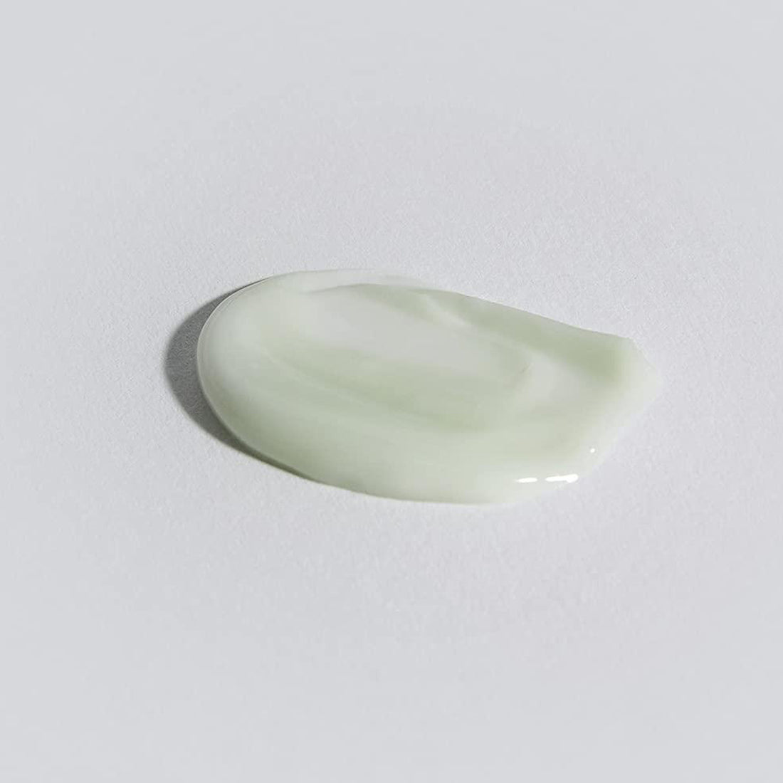 Light green teardrop-shaped object on a white background