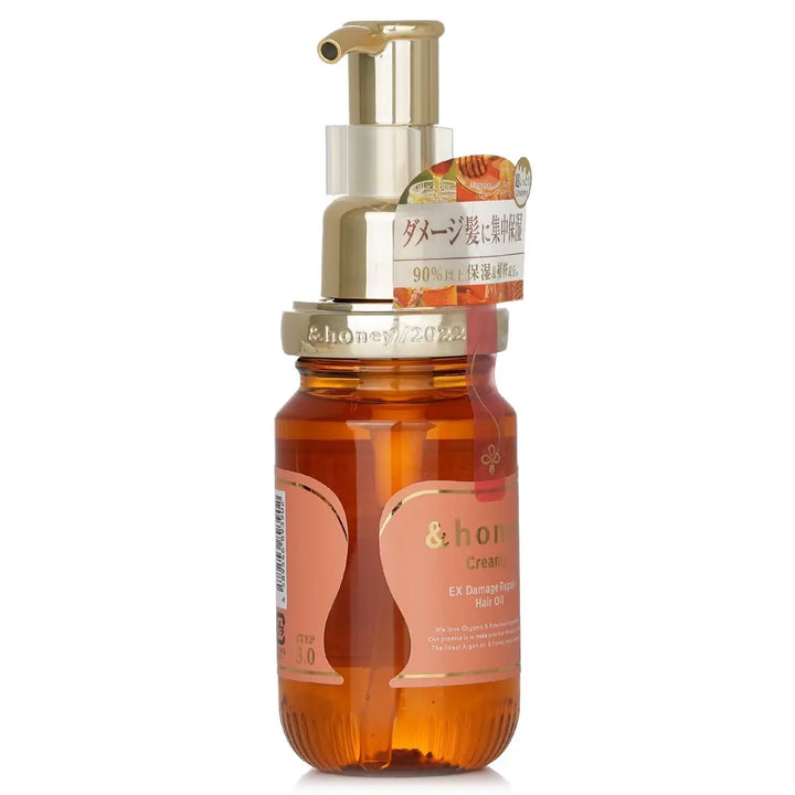 &Honey Creamy EX Damage Repair Hair Oil 100mL in a glass bottle with pump for nourishing dry hair.