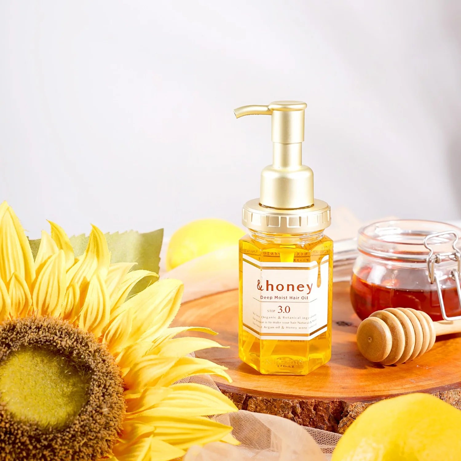 ViCREA &Honey Hair oil bottle with honey and sunflower on a wooden surface