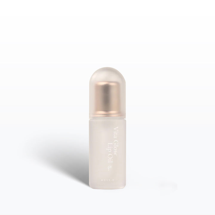 Skincare bottle with a white body and rose gold cap on a light gray background