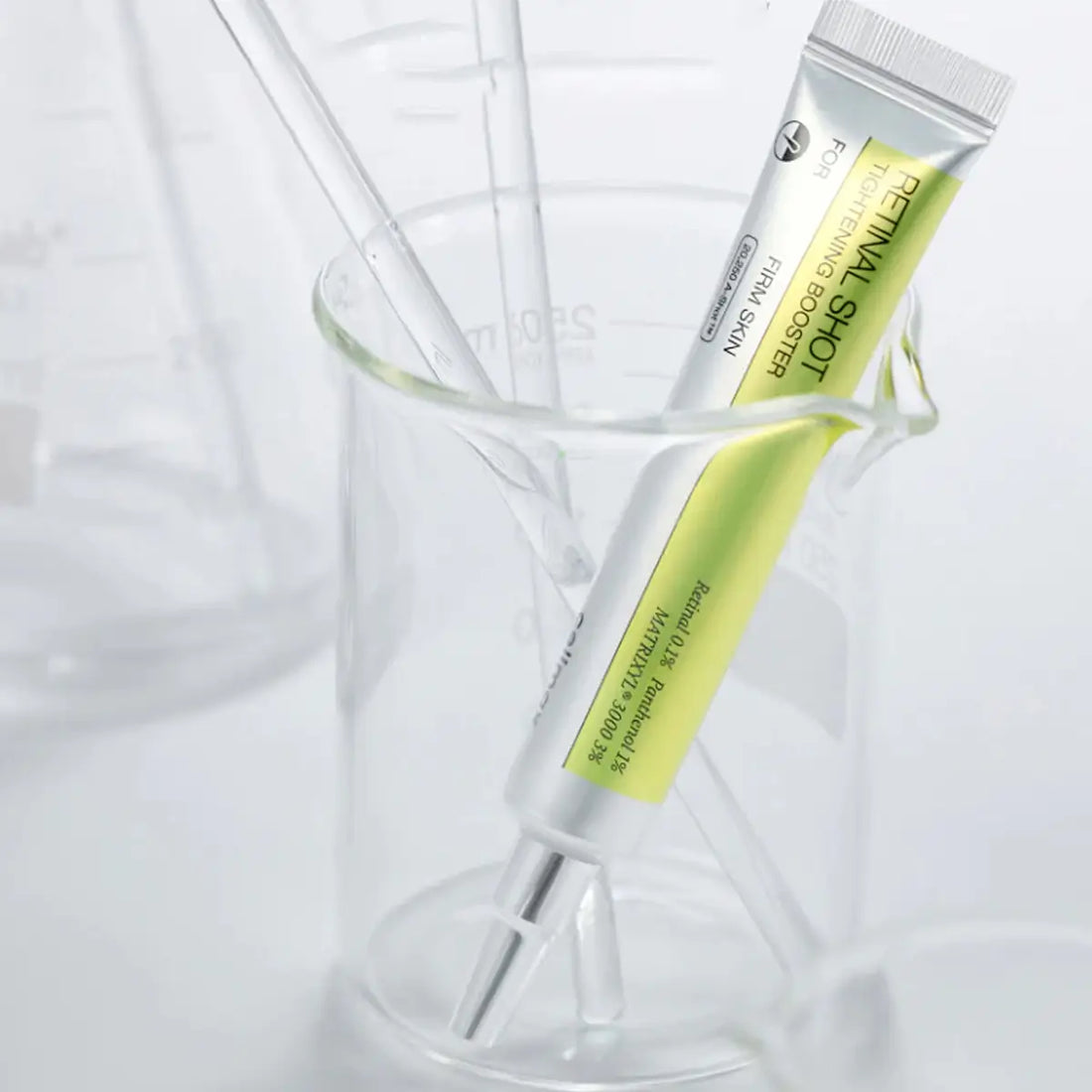 Two tubes of cosmetic product on a white background