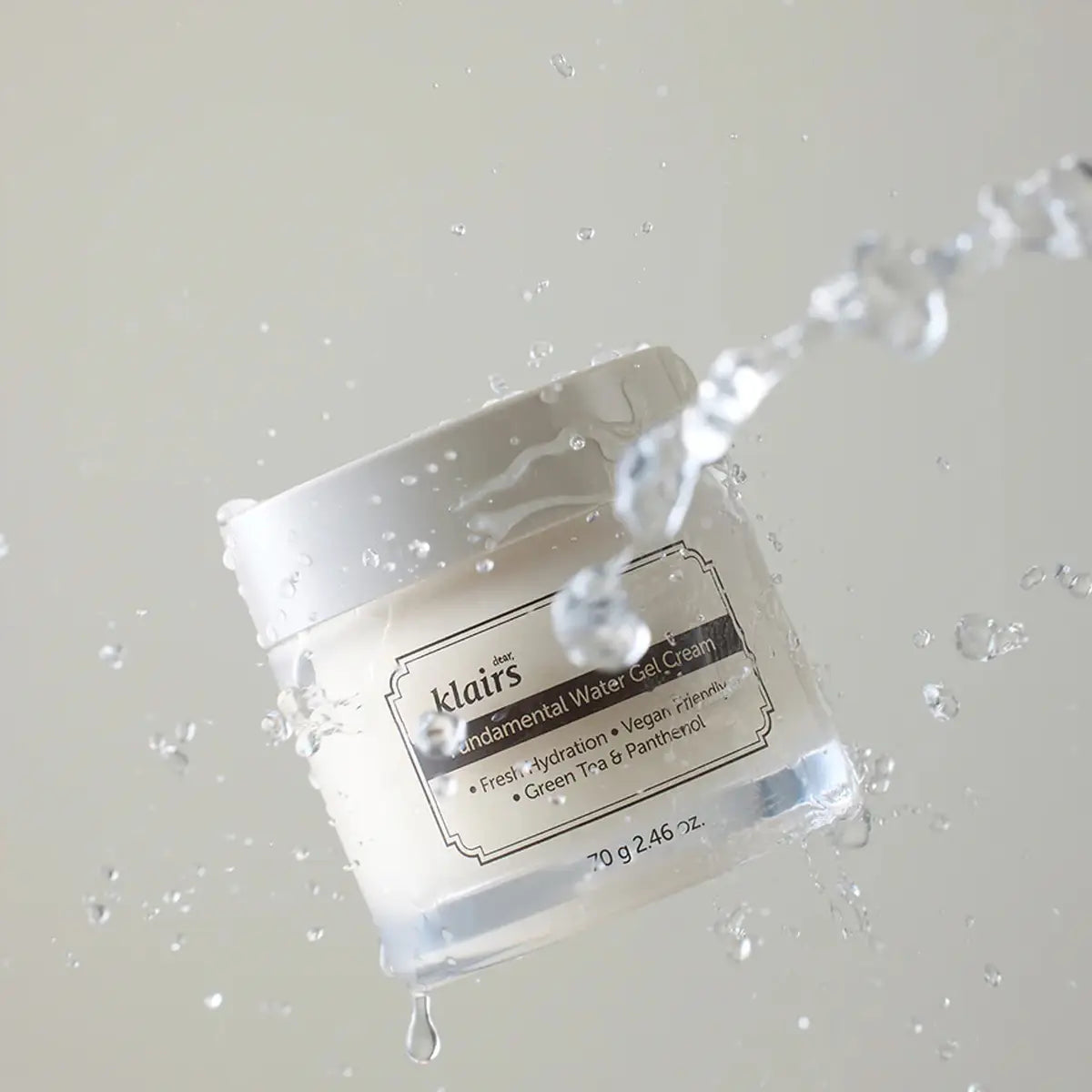 Klairs jar of Fundamental Water Gel Cream with water droplets on a light gray background