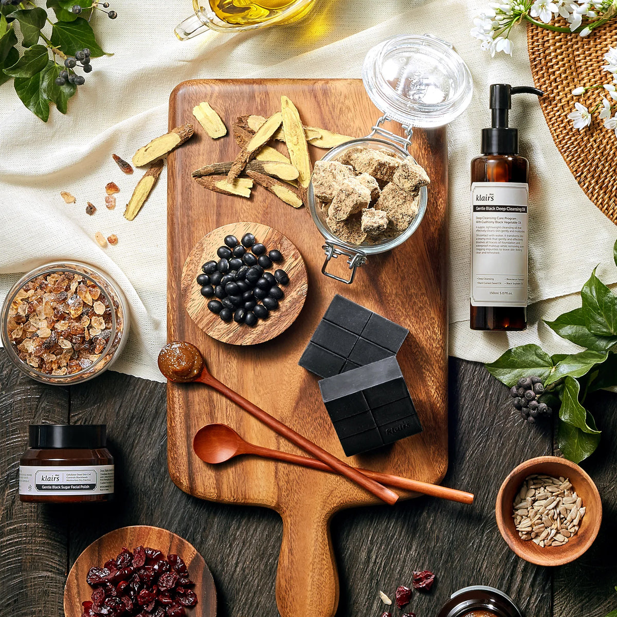 Wooden cutting board with various ingredients and a bottle of skincare product on a rustic surface.