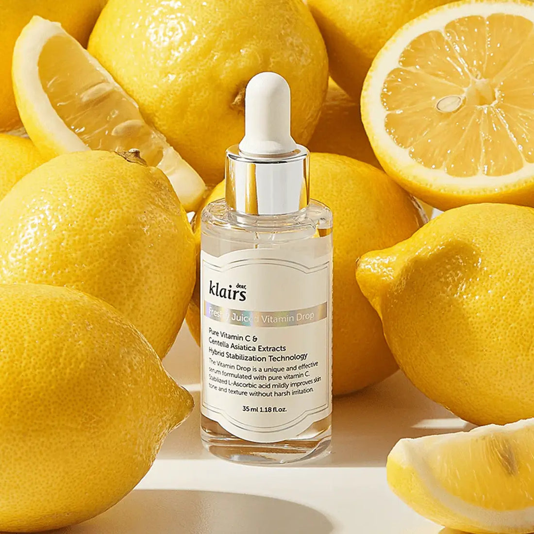 dear KLAIRS Freshly Juiced Vitamin Drop bottle surrounded by lemons on a light background