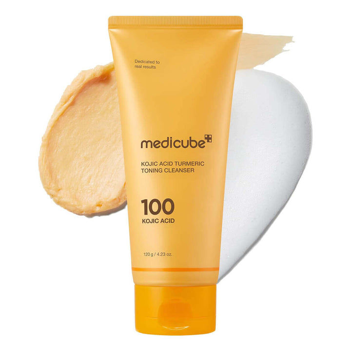 Orange tube of Medicube Kojic Acid Turmeric Toning Cleanser with a white applicator on a white background